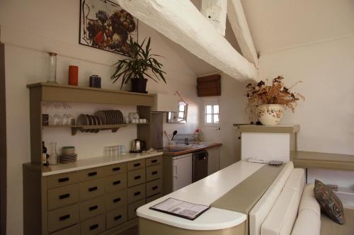 a kitchen with a couch and a counter in a room at Appartement ciel de fugeres in Le Puy en Velay
