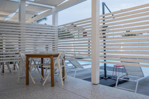 a table and chairs in a room with a wooden wall at La Scala Suite in Realmonte