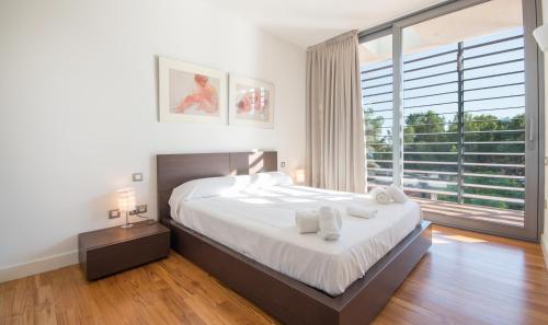 a bedroom with a large bed and a large window at Villa Foixarda near Barcelona, TarracoHomes in Tamarit