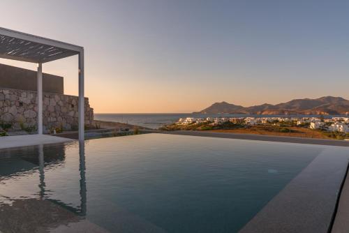 a swimming pool with a view of the ocean at Milos Breeze Boutique Hotel in Pollonia