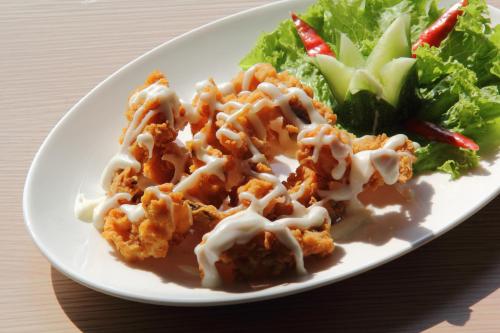 a plate of food with a salad on a table at Tjokro Hotel Klaten in Klaten