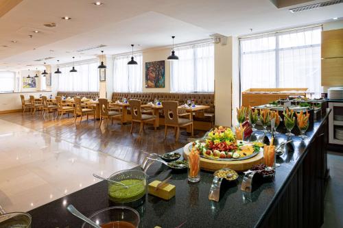 a dining room with a table with food on a counter at Ramada Addis, Addis Ababa in Addis Ababa