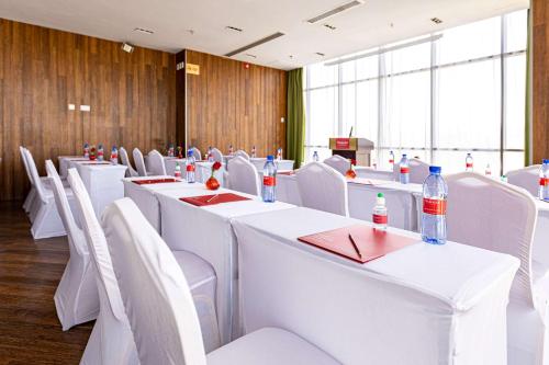 a conference room with white tables and white chairs at Ramada Addis, Addis Ababa in Addis Ababa
