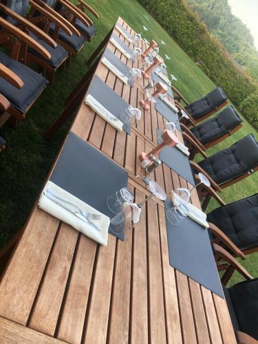 a group of chairs and tables on a wooden deck at Na Vasi restavracija in prenočišča in Škofja Loka