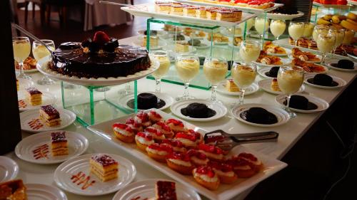 a buffet with cakes and desserts on a table at Lighthouse Golf & Spa Hotel in Balchik