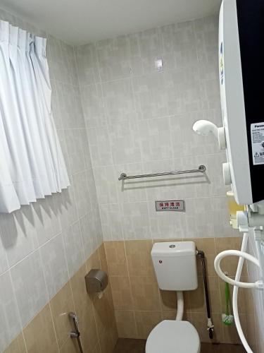 a bathroom with a toilet and a sign on the wall at Ipoh Comfortable Rooms Only-Private Bathrooms Indoor Car Parking SY30 in Ipoh