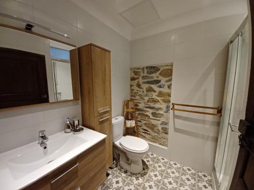 a bathroom with a white toilet and a sink at Casa Pernice in Penta-di-Casinca