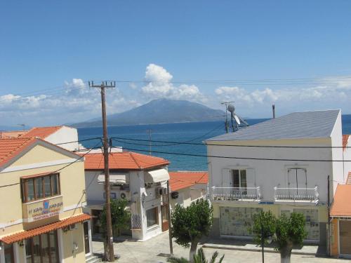 a group of buildings with a view of the ocean at Marialena Pension in Iraion