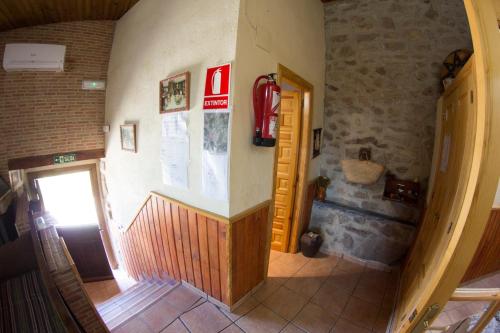 a view of a hallway of a building with a door at CASA DE PIEDRA in Casas del Monte