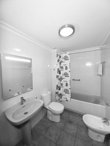 a bathroom with a sink and a toilet and a tub at Centro Playa de Sabinillas Manilva in San Luis de Sabinillas
