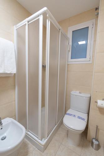 a bathroom with a shower and a toilet and a sink at Alda Centro Pamplona in Pamplona
