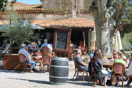 a group of people sitting at an outdoor restaurant at La Souqueto in Mirepeisset