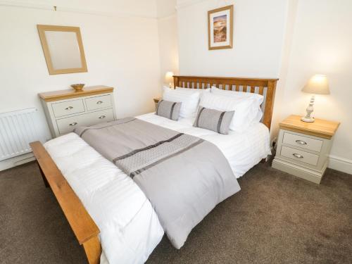 a bedroom with two beds and two night stands at Min Y Don in Colwyn Bay