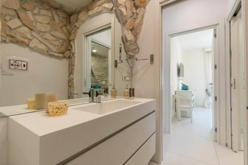 a bathroom with a sink and a large mirror at Port 5 min-Close to Beach Summer Design Wi-Fi in Ischia