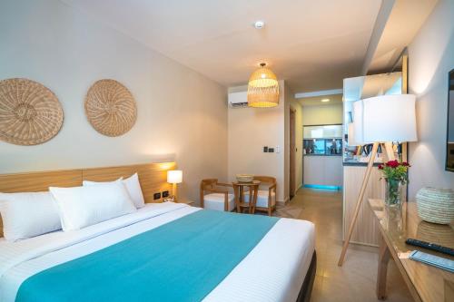 a hotel room with a bed and a table at Redcon Suites in Hurghada