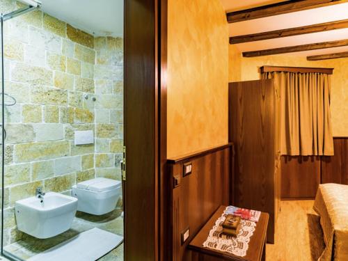 a bathroom with a sink and a toilet at Hotel Castle Park in Berat