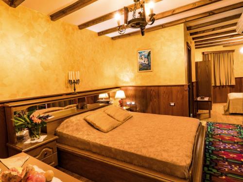 a bedroom with a large bed in a room at Hotel Castle Park in Berat