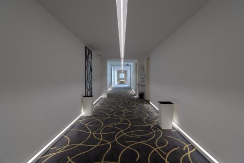 a hallway with a carpet with gold swirls at Holiday Resorts in Balatonszárszó