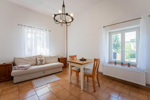 a living room with a couch and a table at Penzion U Babky bylinkářky in Kutná Hora