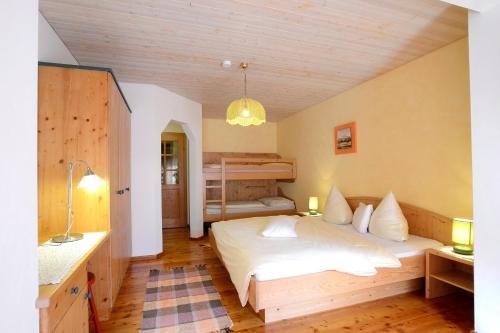 a bedroom with a bed and a bunk bed at Appartementhaus Angerer - Feriendomizile Pichler in Heiligenblut