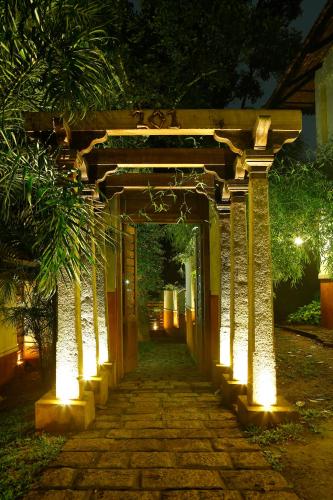 an archway with lights on it at night at Greenwoods Resort, Thekkady in Thekkady