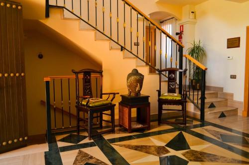 a lobby with stairs and chairs on a checkered floor at The Marbella Heights Boutique Hotel in Marbella
