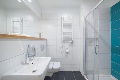 a bathroom with a sink and a toilet and a shower at Hotel Traffic Wrocław Stare Miasto in Wrocław