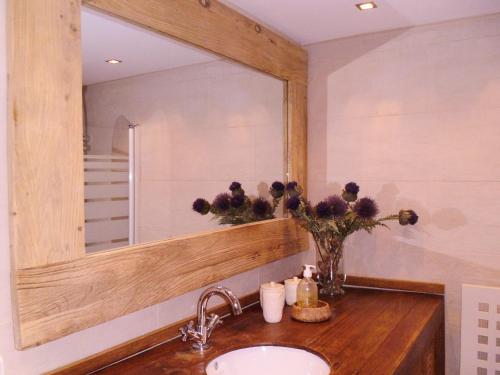 a bathroom with a sink and a large mirror at Petit Ours in Villars-sur-Ollon