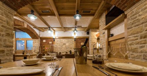 a dining room with a table with plates and glasses at Apartmani Rubinić in Turanj