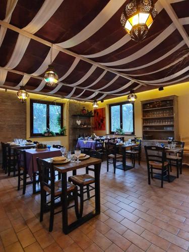a dining room with tables and chairs in a restaurant at Bio Agriturismo Valle dei Calanchi in Castiglione in Teverina