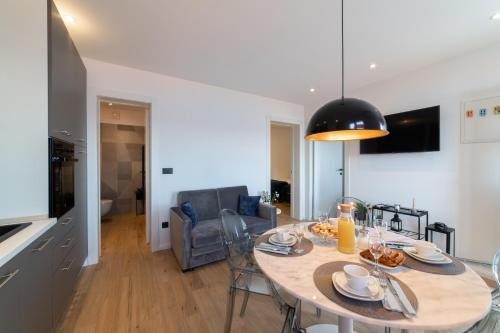 a kitchen and living room with a table and chairs at Apartment Lea in Stanići