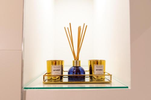a glass shelf with three perfume bottles on it at Apartment Lea in Stanići