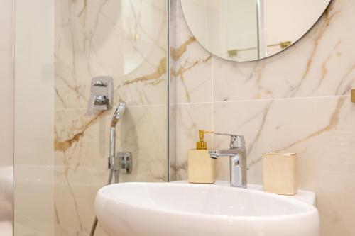 a bathroom with a sink and a mirror at Apartment Lea in Stanići