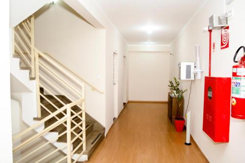 a hallway with a staircase in a house at Hotel GMatos Belo Horizonte - Próximo a Rodoviária e Mercados Turísticos in Belo Horizonte