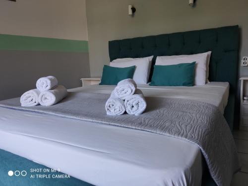 a bed with towels on top of it at Iason studio 2 in Patitiri