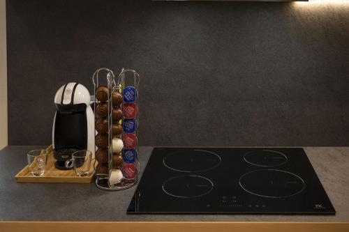 a kitchen counter with a coffee maker and a stove at Casa Galèt in Tirano