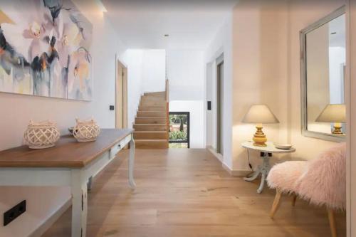 a hallway with a bench and a table in a room at Villa Ona in Port de Soller