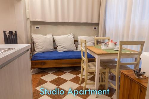 a kitchen with a couch with a table and chairs at BolognaRoomscom - Santo Stefano Apartments in Bologna