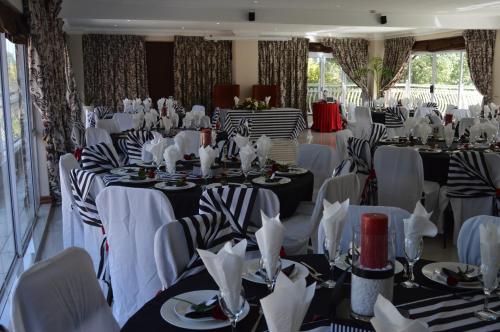 a set up for a banquet with tables and chairs at Lakeview Boutique Hotel & Conference Center in Benoni