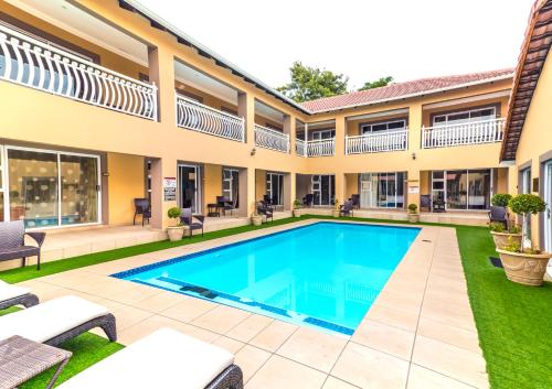a swimming pool in the courtyard of a house at Lakeview Boutique Hotel & Conference Center in Benoni