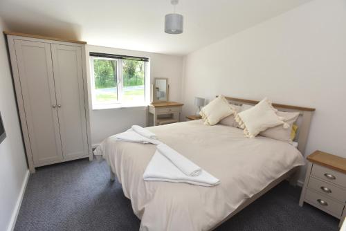 a bedroom with a large bed and a window at col's mere in Upton