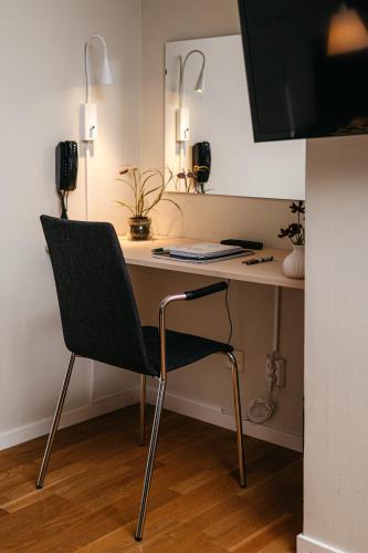 a desk with a chair in a room at Hotell Björken in Umeå