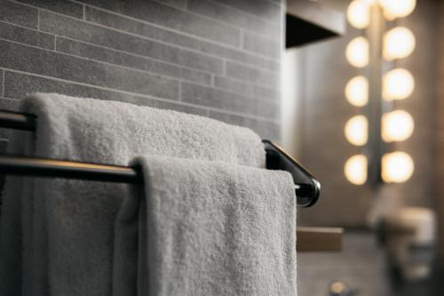 a group of towels hanging on a towel rack in a bathroom at Hotell Björken in Umeå