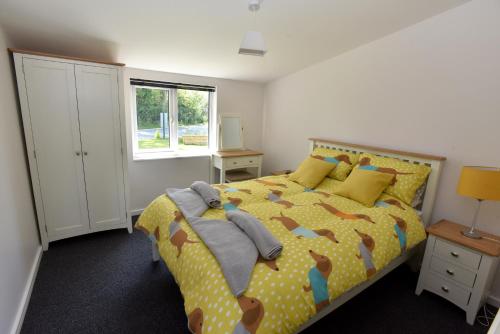 a bedroom with a bed and a window at col's mere in Upton