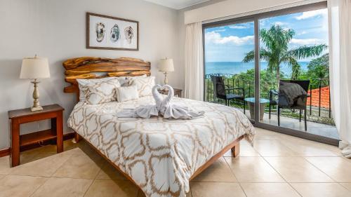 Un dormitorio con una cama con vista al mar. en Elegant Oceanview Condo with Spacious Open-Concept Floor Plan and Inviting Beach Design, en Playa Flamingo