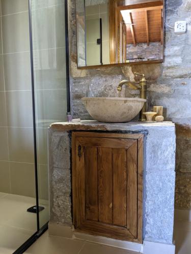 a bathroom with a sink and a shower at Bahab Guest House in Doğanbey