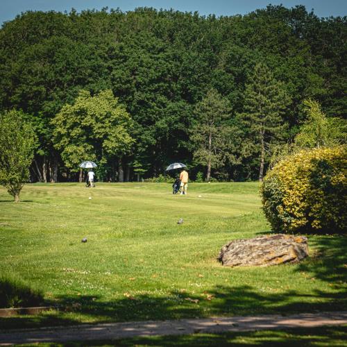 a group of people walking in a park with umbrellas at Domaine de Roiffé in Roiffé