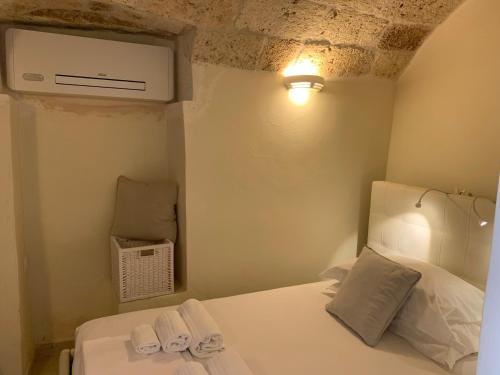 a bedroom with a bed with two towels on it at Amoredimare Casa Vacanze in Polignano a Mare