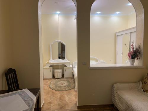 a bathroom with a sink and a tub and a mirror at Celebrity in Kamianets-Podilskyi