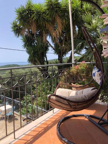 a hammock on a balcony with a view of the ocean at Elena Rista Studios in Parga